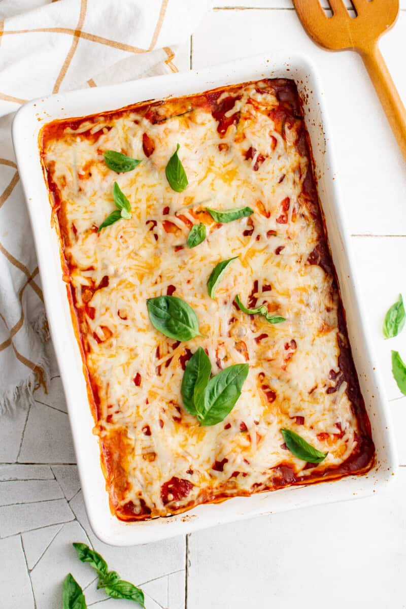 overhead view of zucchini ravioli in a white rectangular baking pan.