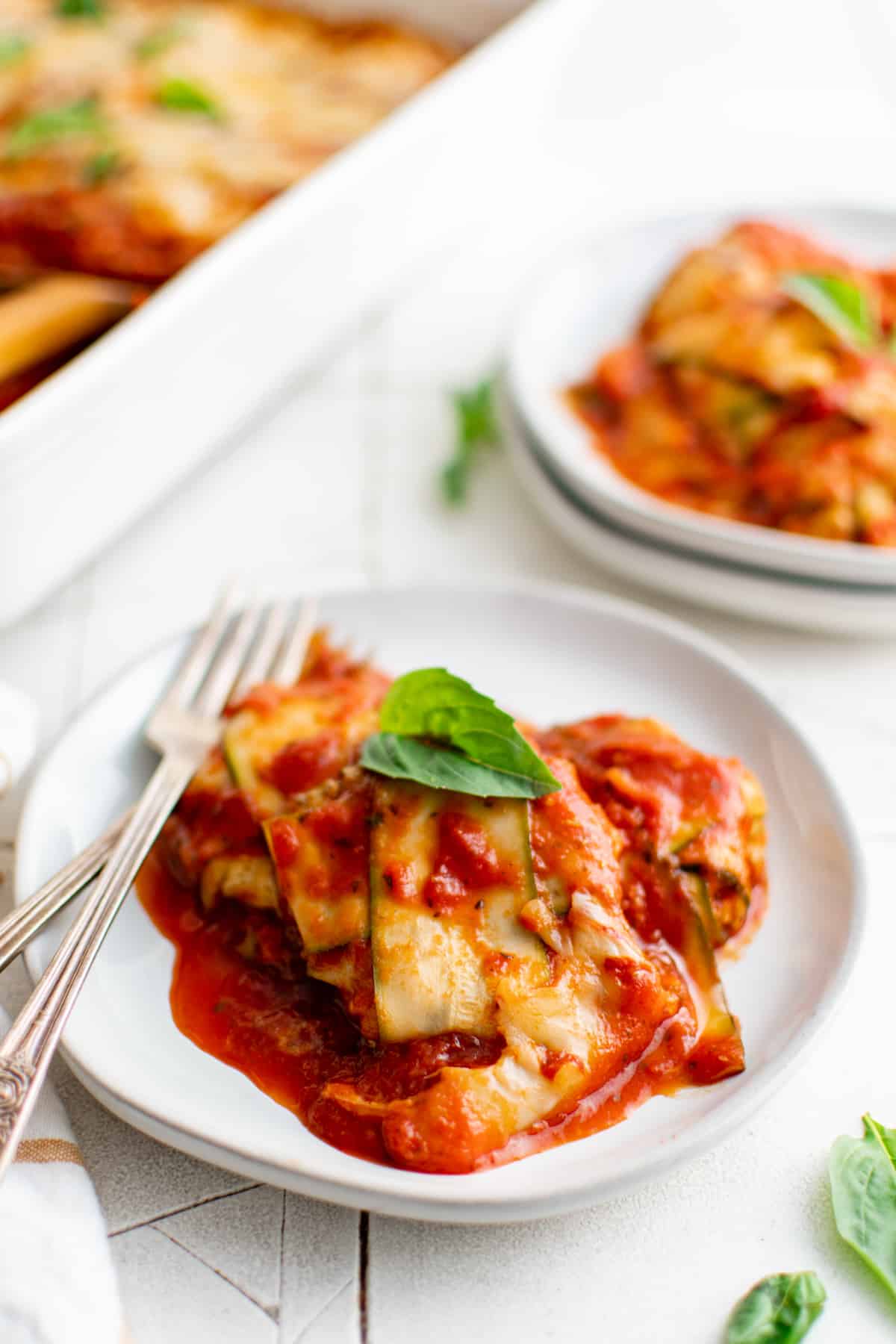 a small plate of zucchini ravioli in marinara sauce