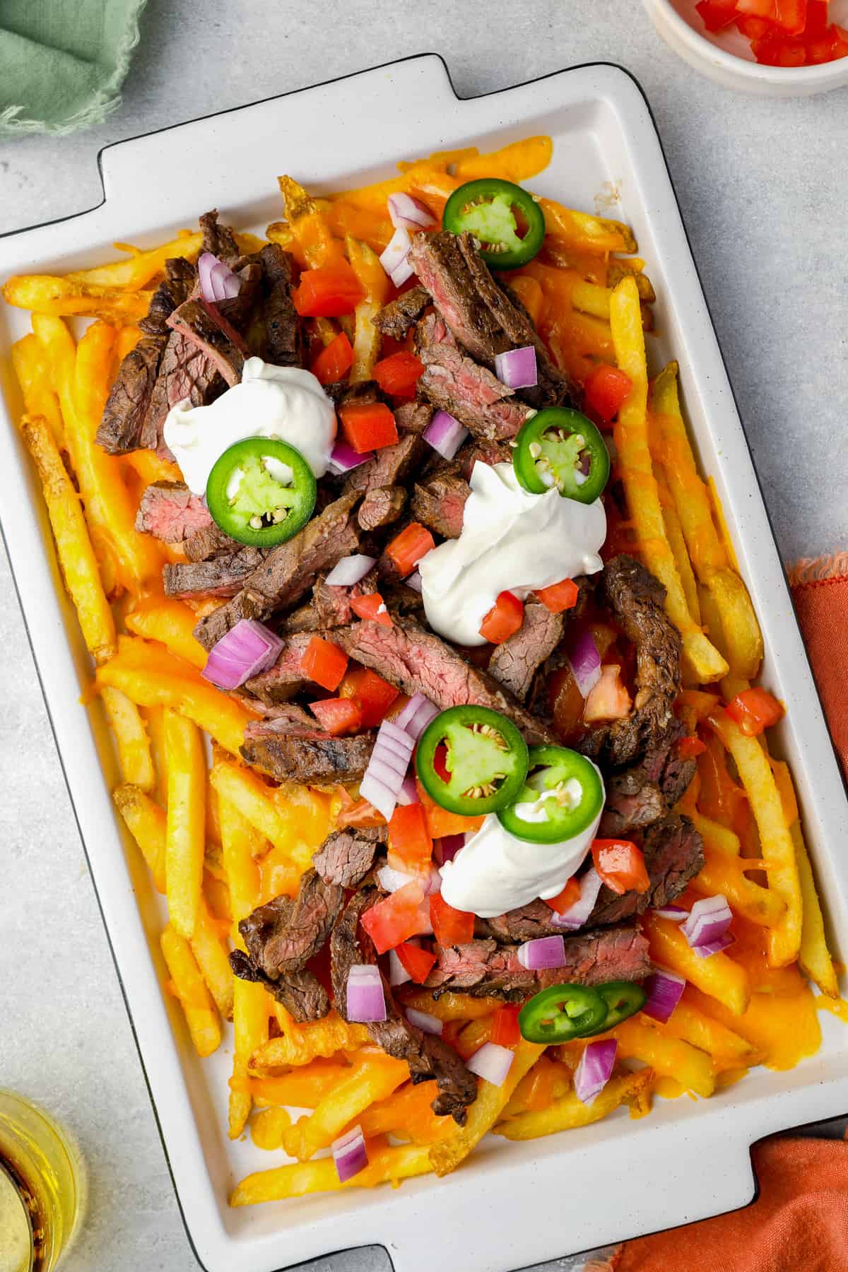 overhead view of carne asada fries on a white tray.