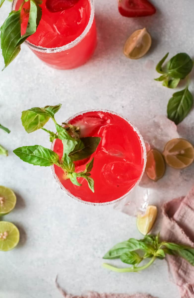 overhead view of 2 strawberry basil margaritas.