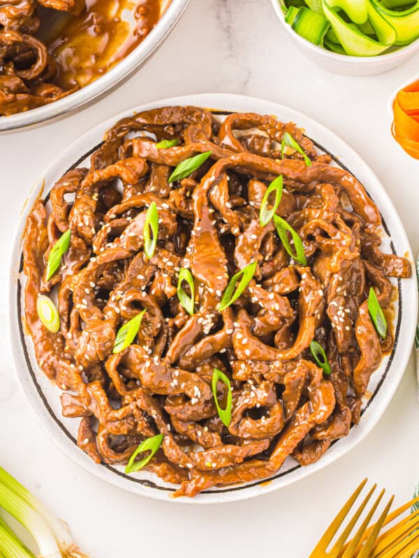 a plate of korean beef on a white table.