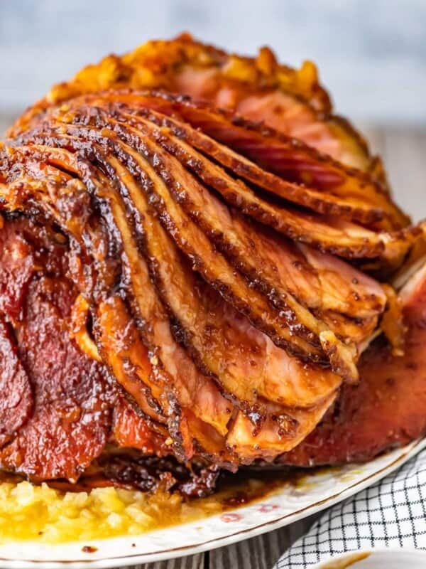 This Brown Sugar Pineapple Ham is the perfect Easter Ham recipe! We made a delicious cola and brown sugar glaze for ham, and combined it with crushed pineapples. This spiral ham is easy to make, and filled with SO much flavor!