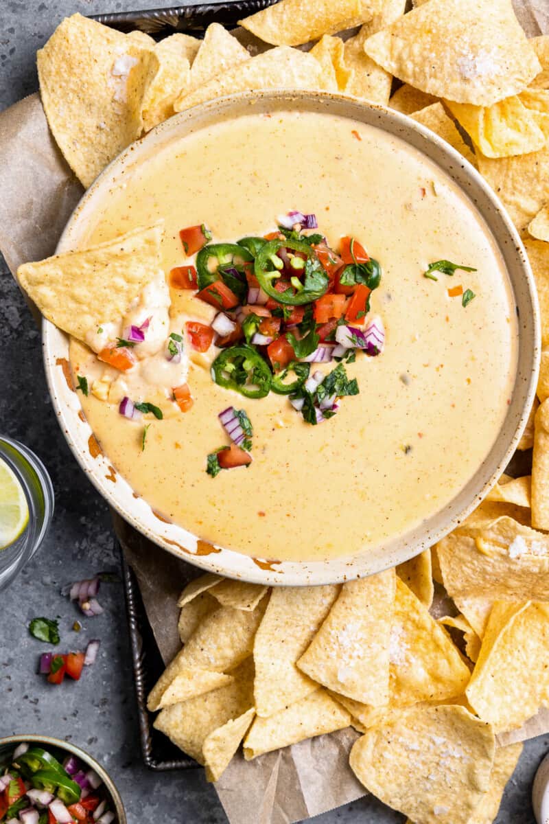 mexican cheese dip with chips and salsa.