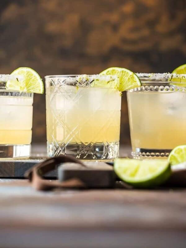 margaritas in glasses with lime garnish