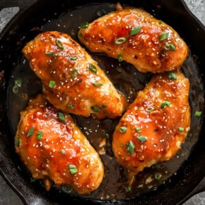 asian chicken breasts in a cast iron skillet.