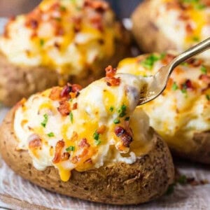 fork lifting up cheese on twice baked potato