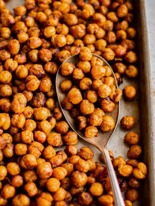 roasted chickpeas on a baking sheet with a spoon.