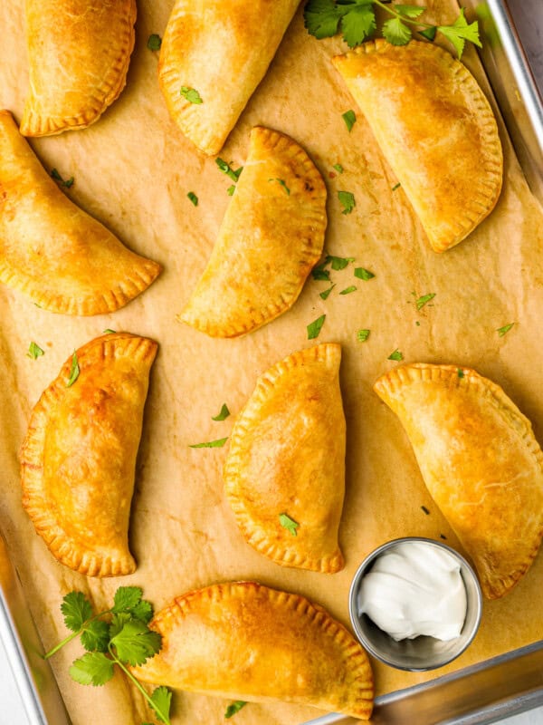 mexican empanadas on a baking sheet.