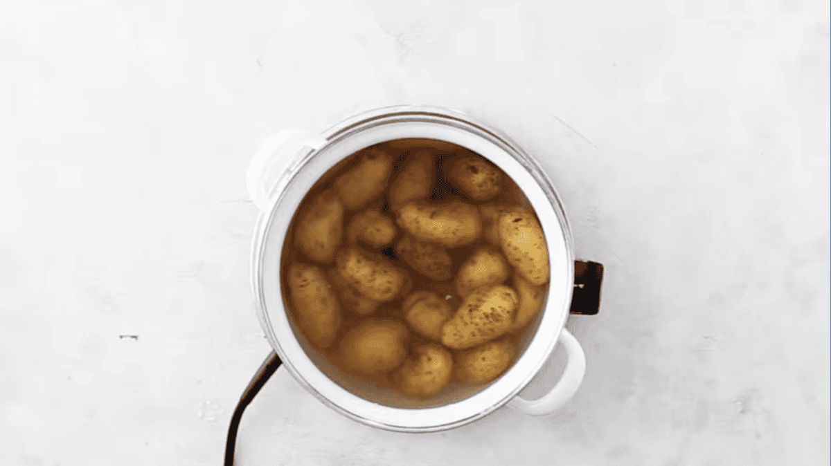 whole potatoes in a pot of water.