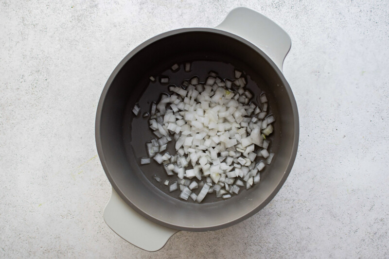 onion in a bowl on a white surface.