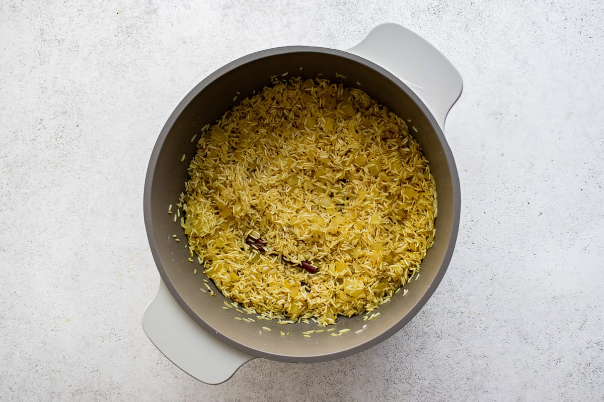 fried rice in a bowl on a white surface.