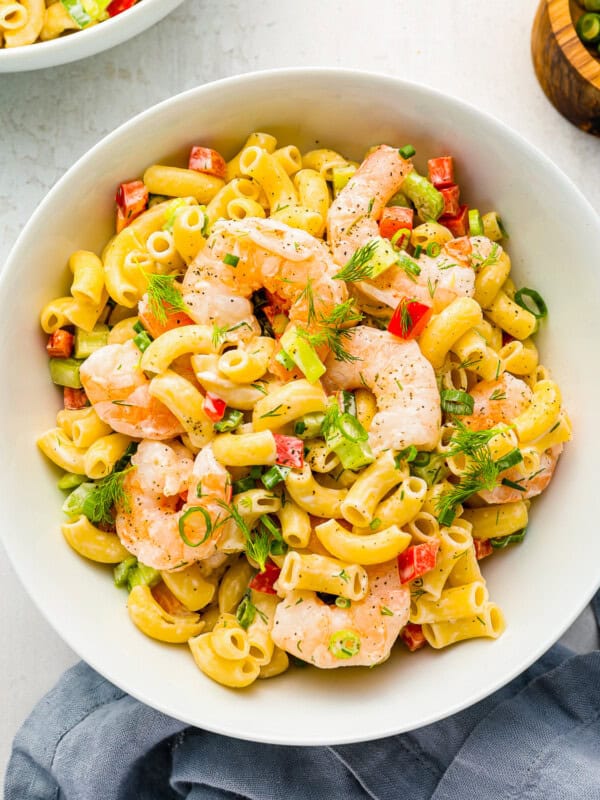 overhead view of shrimp pasta salad in a white bowl.