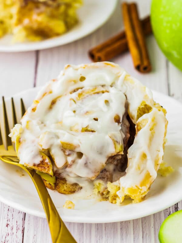 apple cinnamon rolls with icing on a plate.