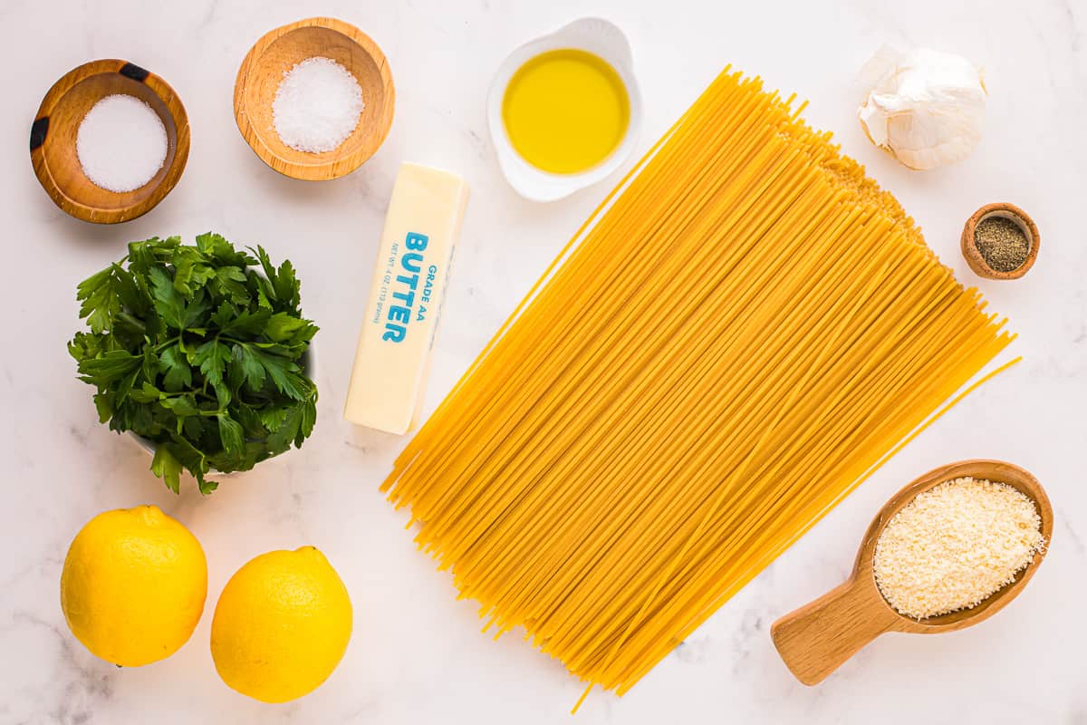 ingredients for a pasta dish with lemons, garlic and parmesan cheese.