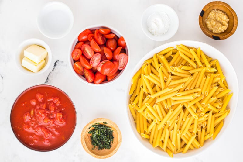 ingredients for penne pasta with tomatoes and basil.