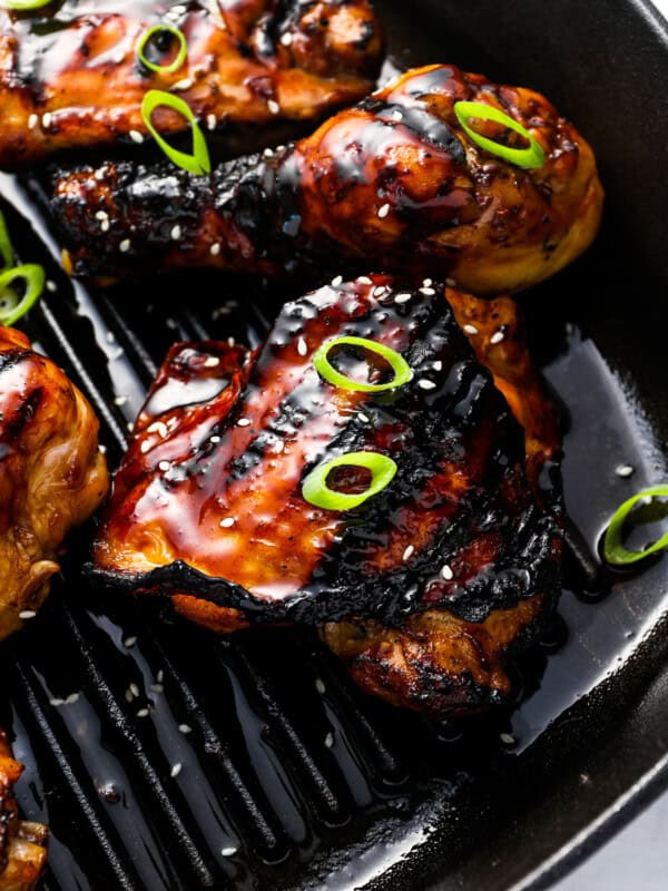 close up view of korean bbq chicken on a grill pan.