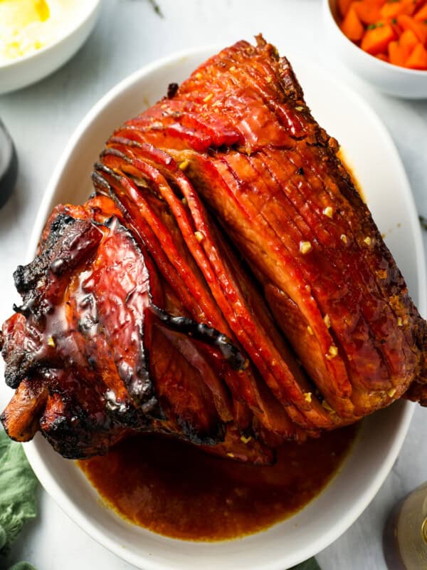 overhead view of smoked ham on a white plate.