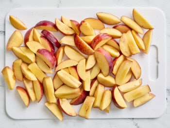 sliced peaches on a cutting board.