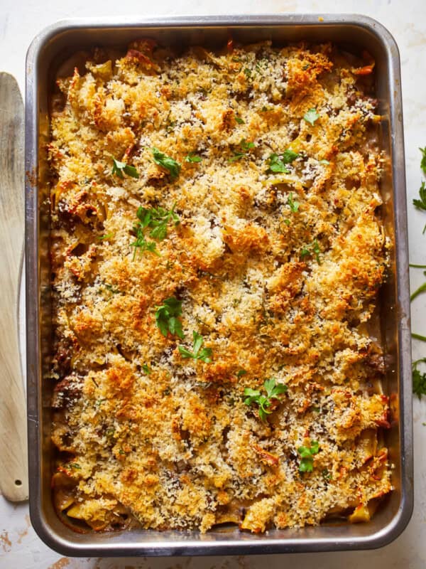 a baking dish filled with pasta and parmesan cheese.