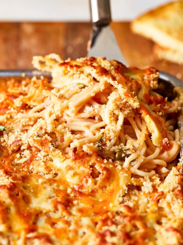 a dish of spaghetti and meatballs in a baking dish.