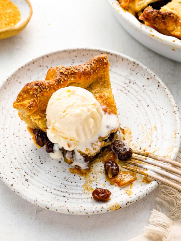 a slice of pie with ice cream on a plate.