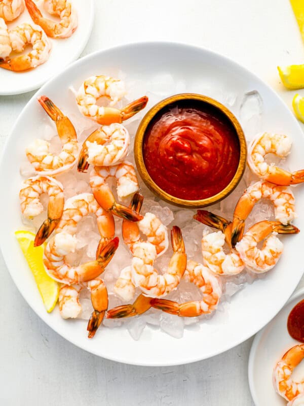 shrimp on ice with a dipping sauce.