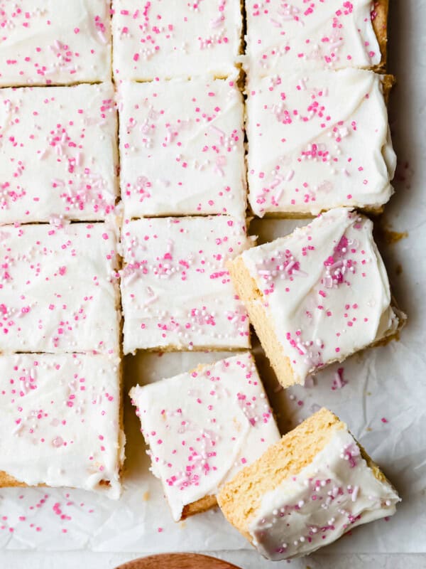 a sheet of white and pink frosted bars on a baking sheet.