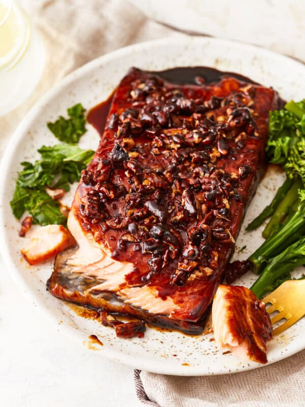 A plate with salmon and greens on it.