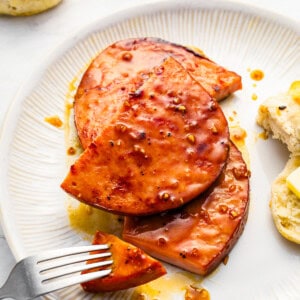 A plate of food with a fork and biscuits.