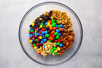 A bowl full of mixed nuts and m&m's.