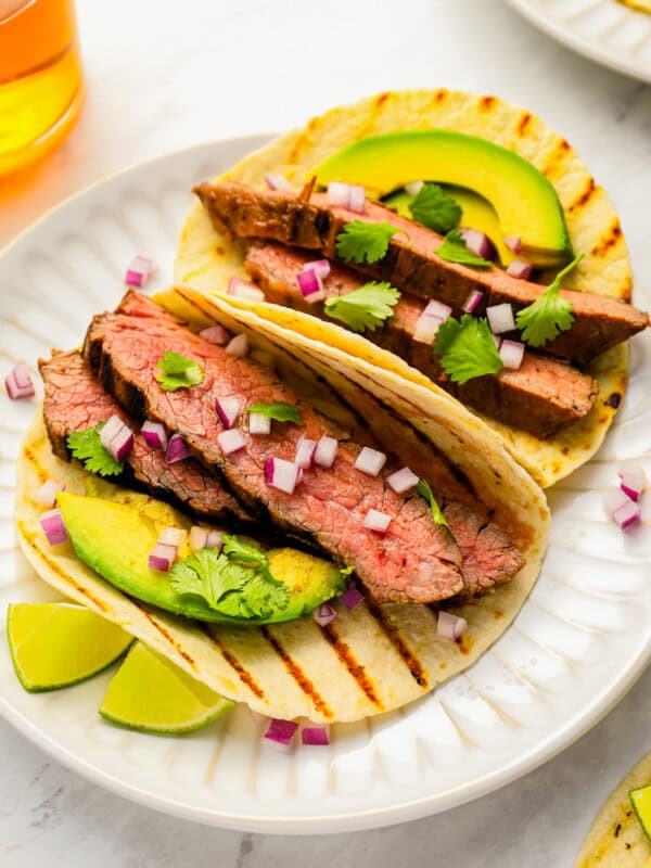 Grilled steak tacos with avocado and lime.