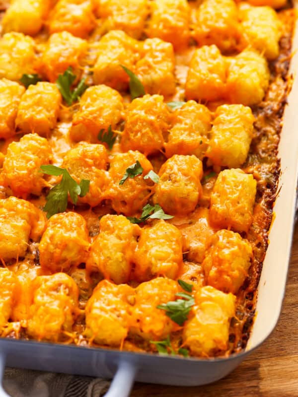 Cheesy tater tot casserole in a blue dish.