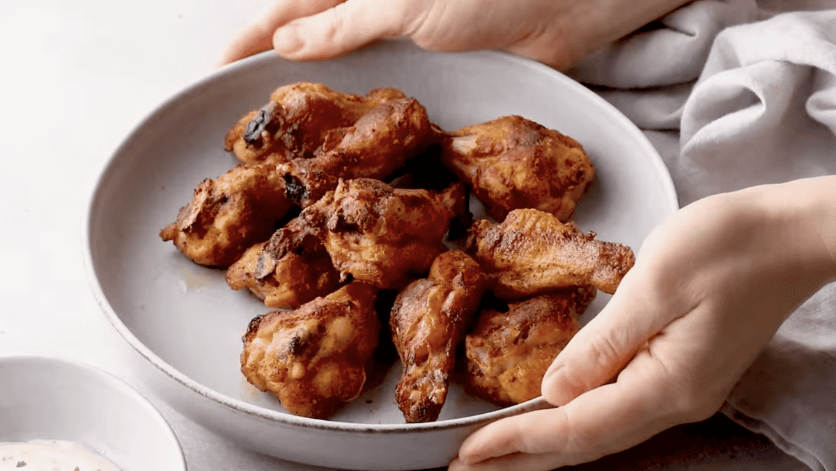 baked chicken wings in a gray serving bowl.