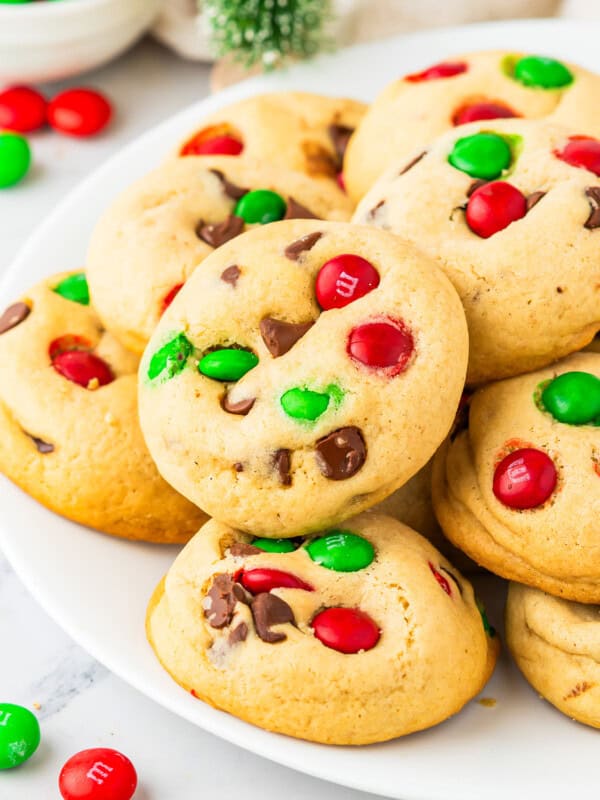 A plate of cookies with m & m's on it.