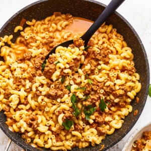 Macaroni and cheese in a skillet on a white background.