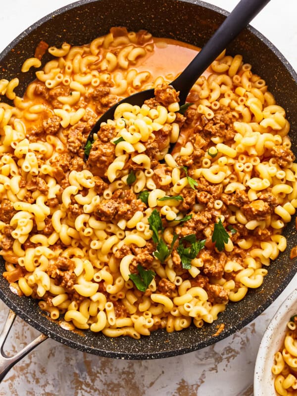 A skillet with macaroni and meat in it.