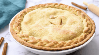 a baked homemade apple pie in a pie pan.