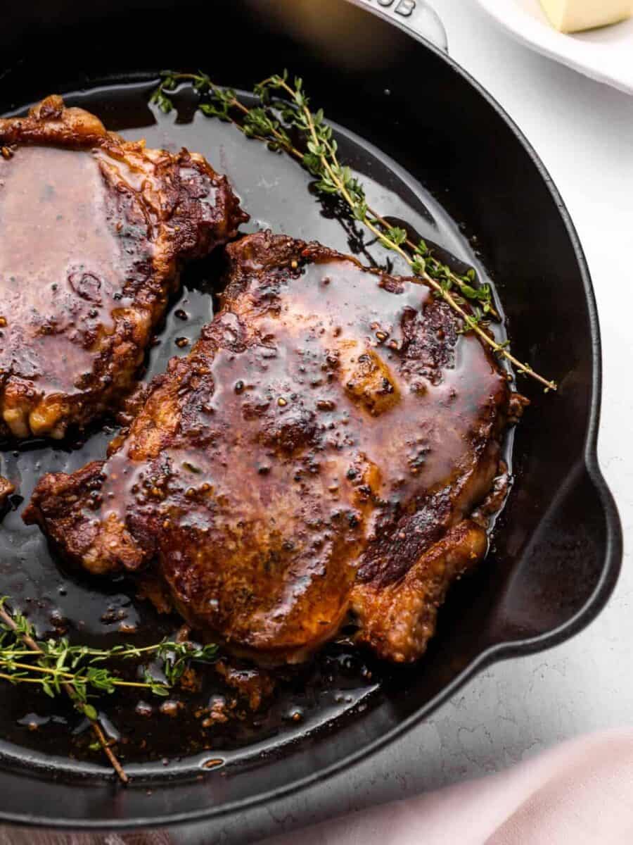 oven baked steaks in a cast iron pan with thyme.