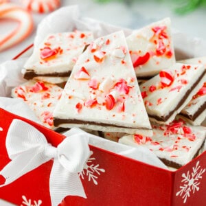 Peppermint bark in a red box with candy canes.