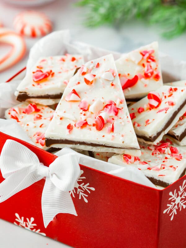 Peppermint bark in a red box with candy canes.