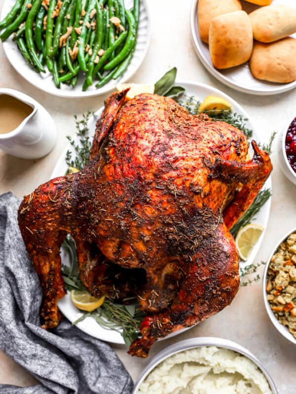 Thanksgiving dinner with roasted turkey, green beans, mashed potatoes and cranberry sauce.