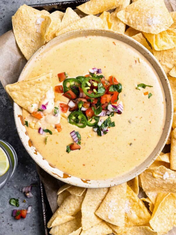 mexican cheese dip with chips and salsa.