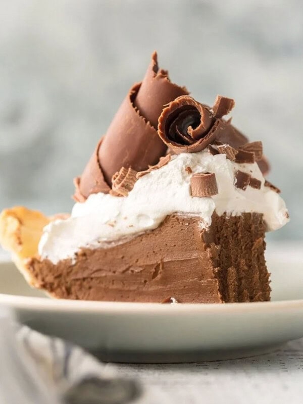 A slice of French silk pie on a white plate.