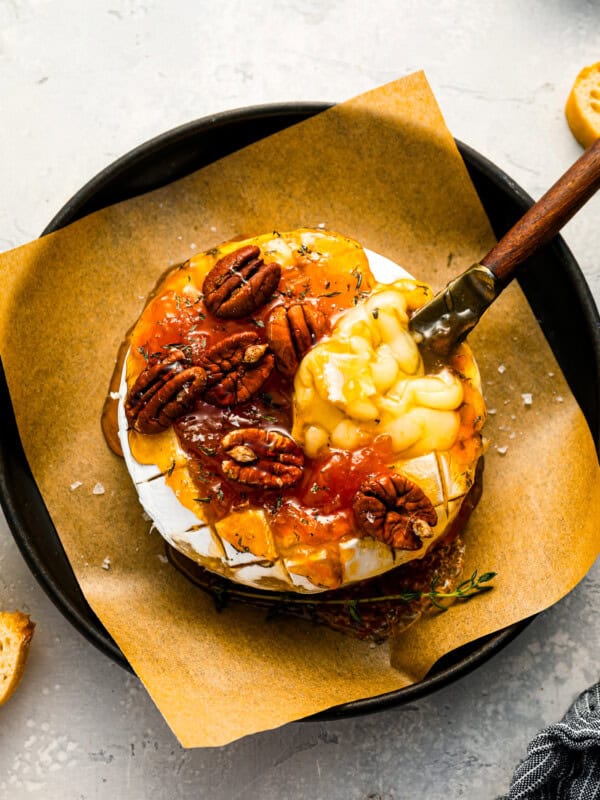 A plate with cheese and pecans on it.