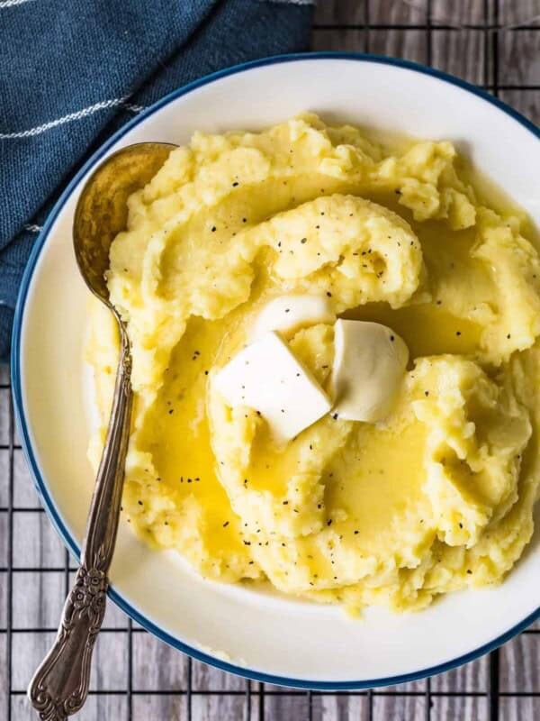 creamy mashed potatoes in a bowl with butter and a spoon