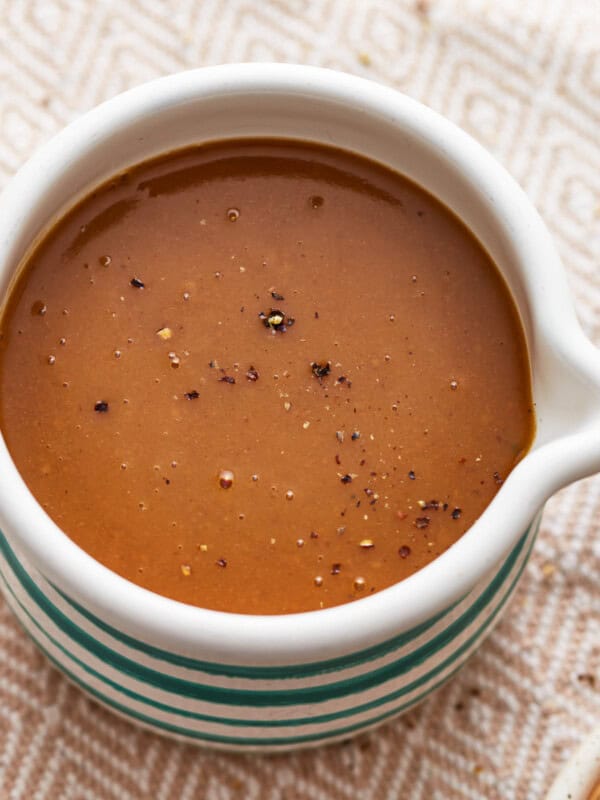 A bowl of make ahead turkey gravy on a table.