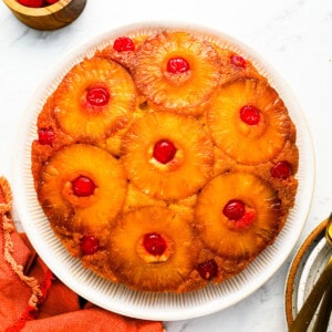 A pineapple upside down cake on a plate.