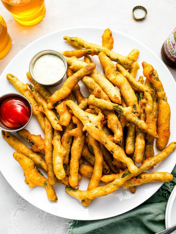 A plate of french fries with dipping sauce.