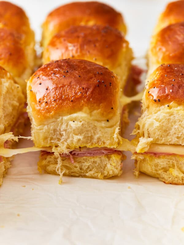 Ham and cheese sliders on a baking sheet.