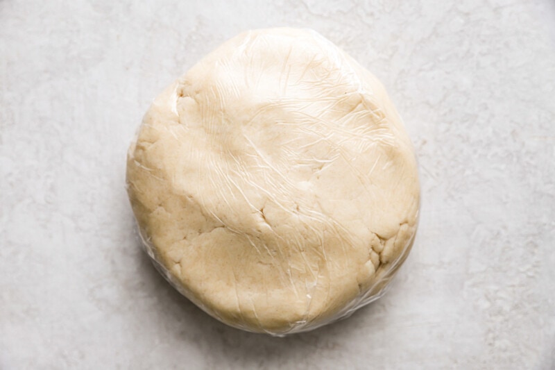 A ball of dough on a white surface.